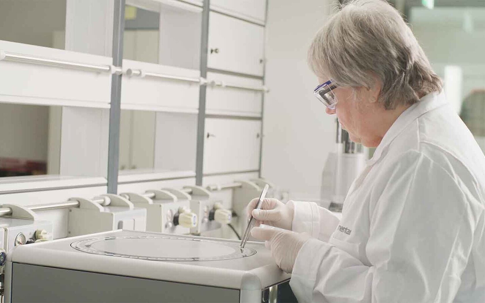 Female lab employee is placing samples on an elemental analyzer