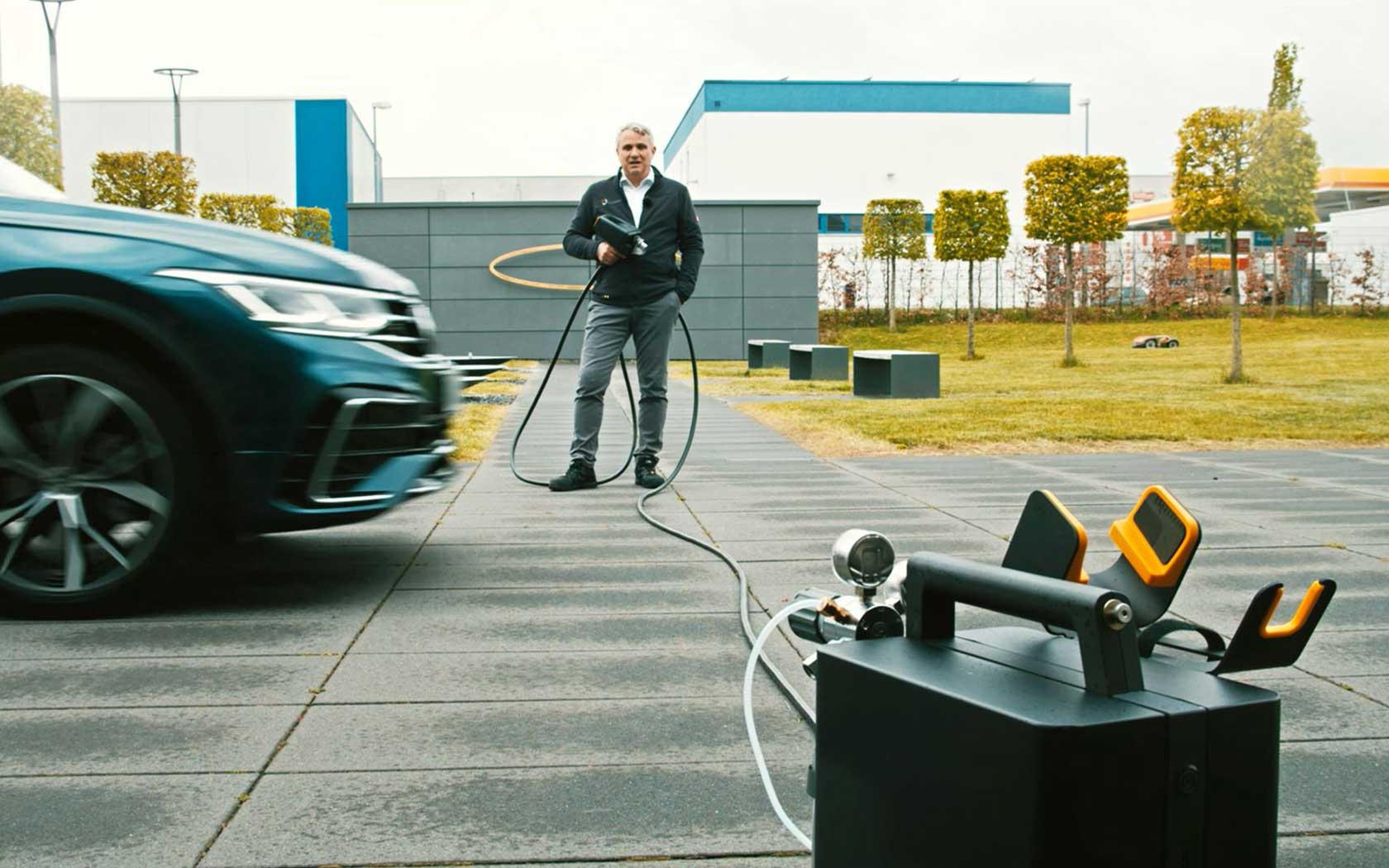 Mobile spark spectrometer in front of a car and a man